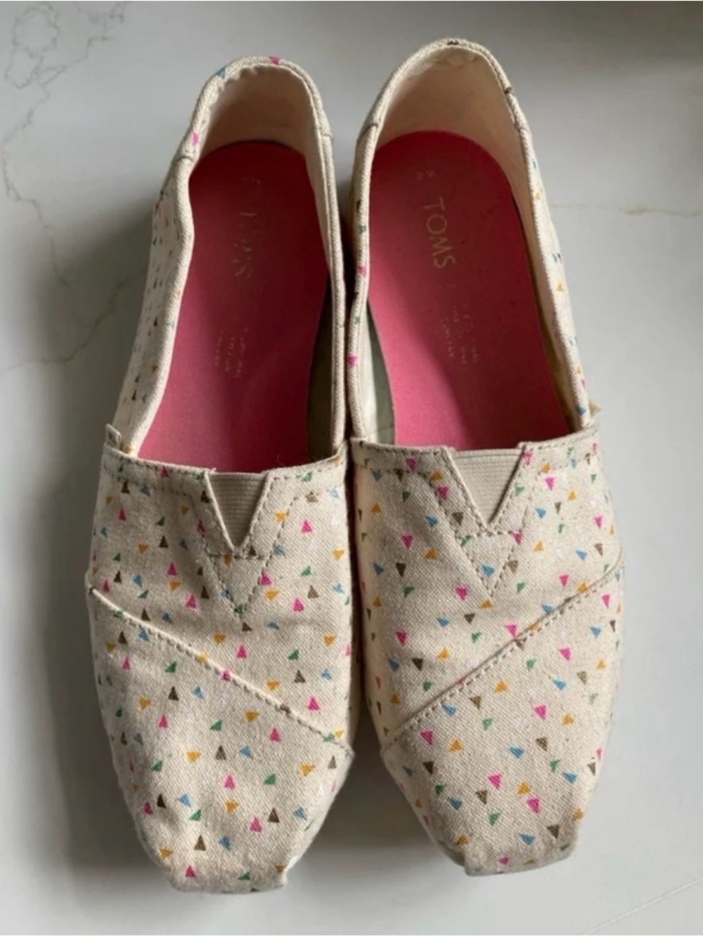 TOMS Cream Canvas Slip-Ons with Pink Insole and Multicolor Triangle Print